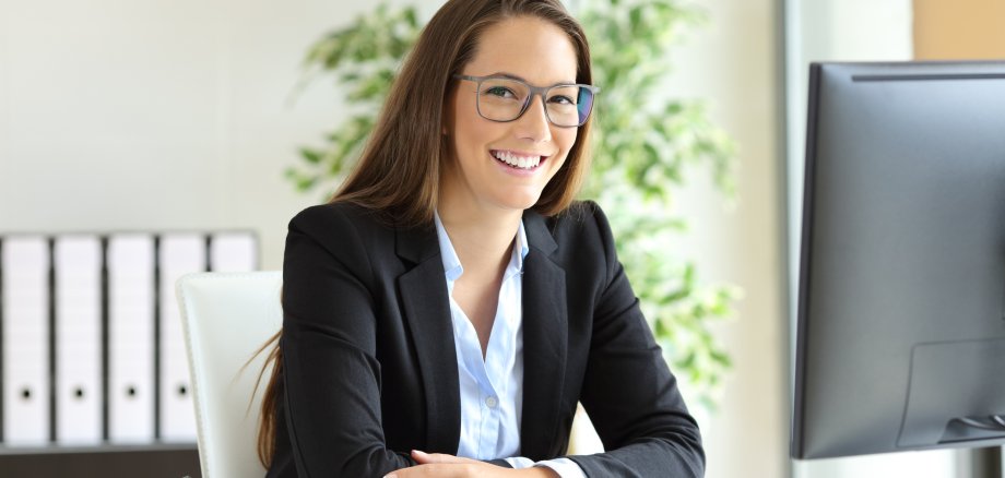 Businesswoman with glasses posing at office